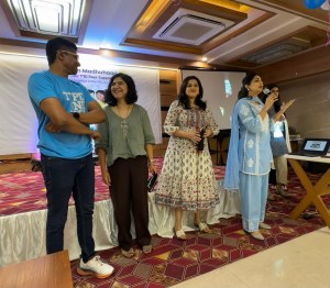 Four people standing on a stage.